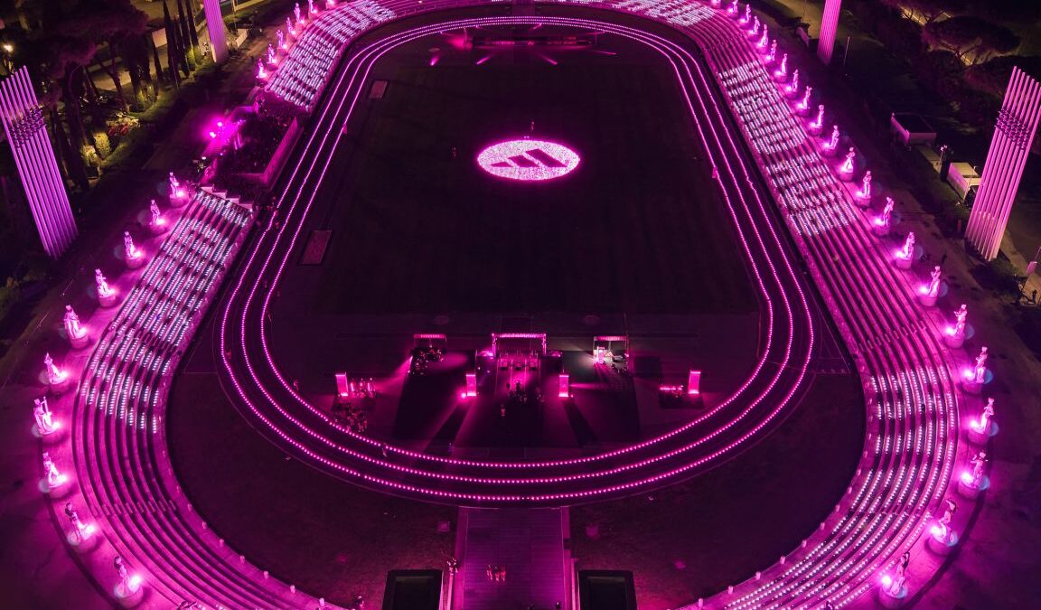 Aerial view of the pink-lit adidas Hybrid Hub at Rome’s Stadio dei Marmi
