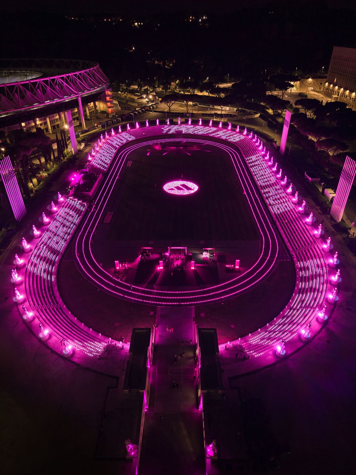 Aerial view of the pink-lit adidas Hybrid Hub at Rome’s Stadio dei Marmi