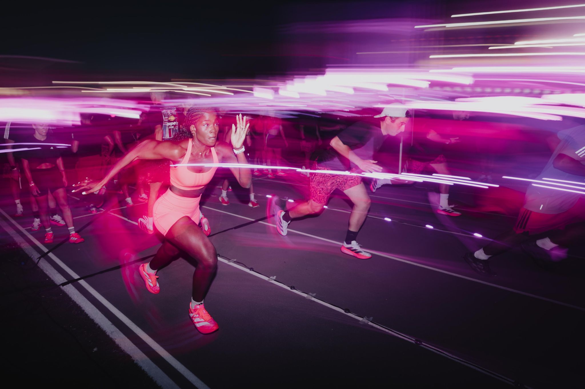 Runners move along the track during the adidas Hybrid Hub activation