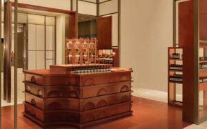 Side view of Aesop’s terracotta counter and fragrance displays at Harrods