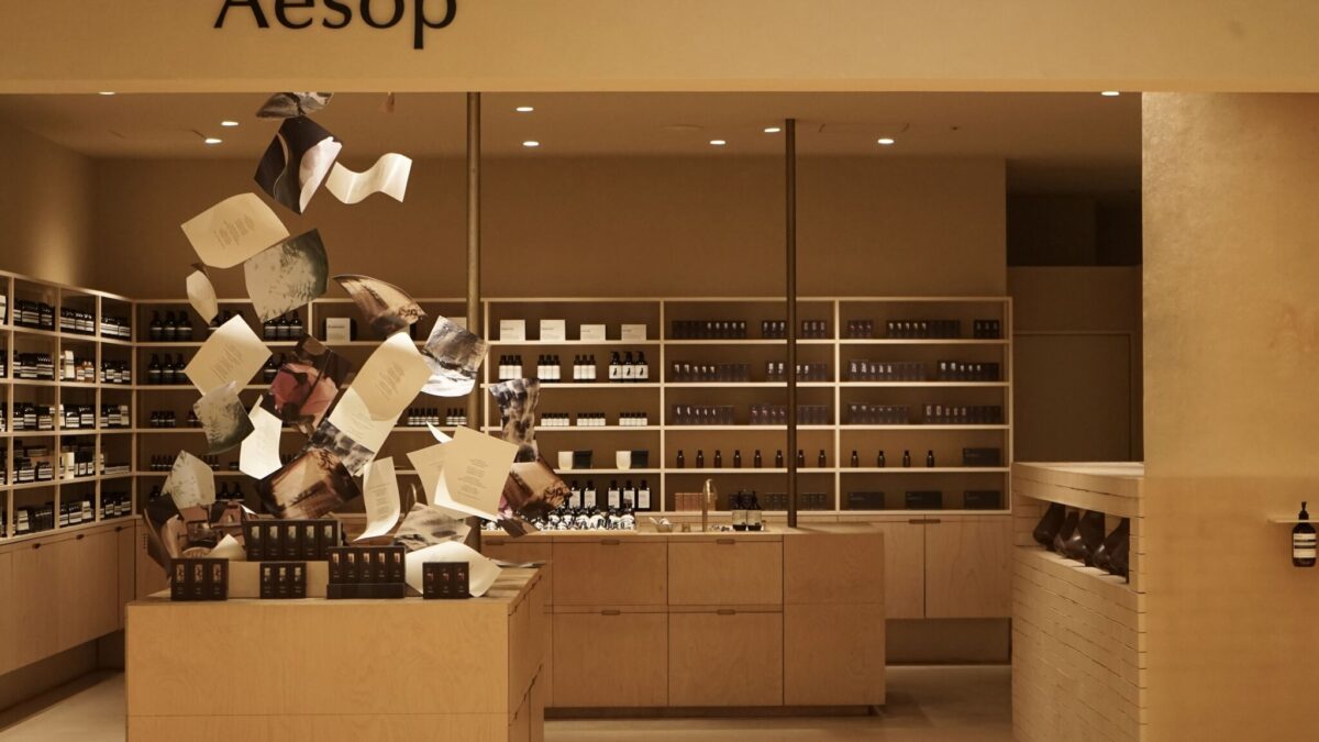 Aesop fragrance display with suspended paper-like forms
