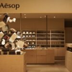 Aesop fragrance display with suspended paper-like forms