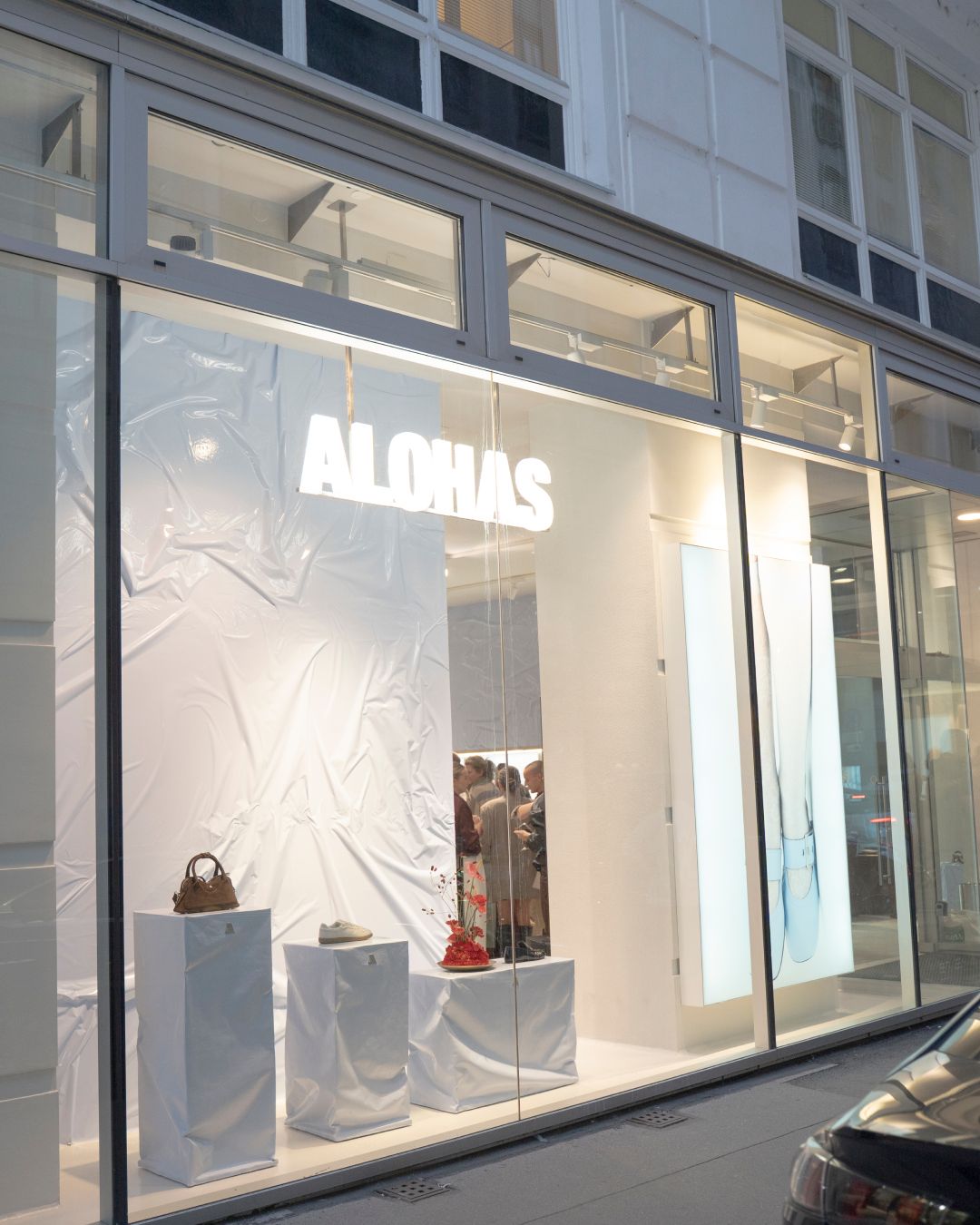 Illuminated ALOHAS storefront at Brandstätte 8 in Vienna