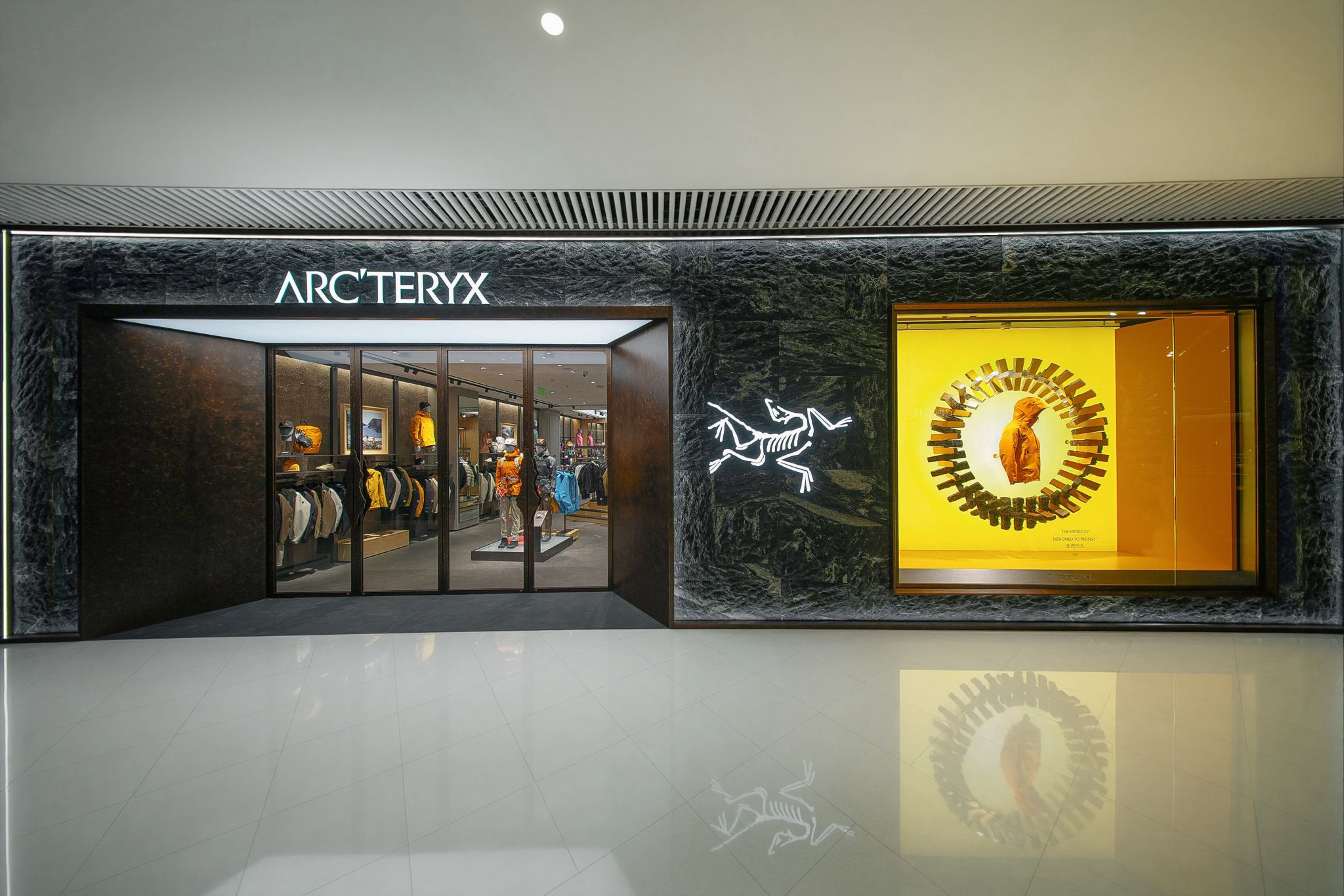 Arc’teryx storefront with a bright yellow product window