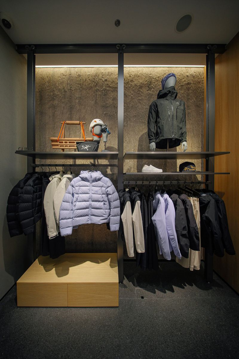 Jackets displayed on perimeter fixtures inside the Arc’teryx store
