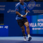 Archival on-court photograph of Kei Nishikori supplied with ASICS advisory announcement
