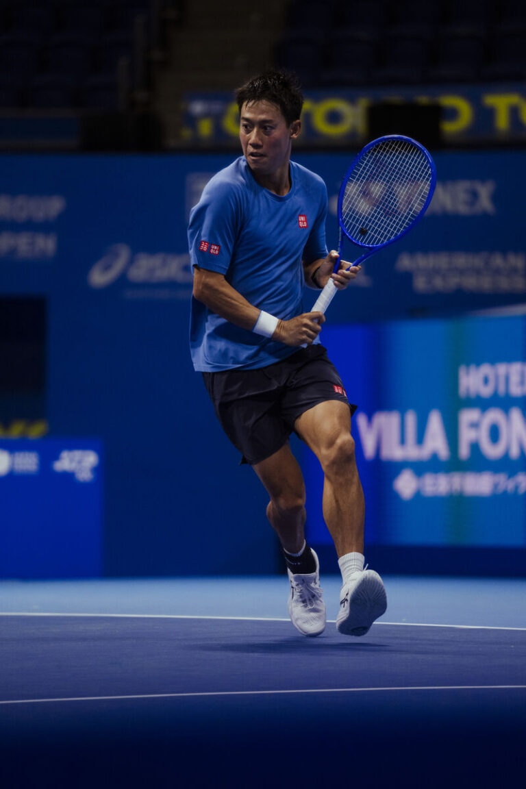 Archival on-court photograph of Kei Nishikori supplied with ASICS advisory announcement