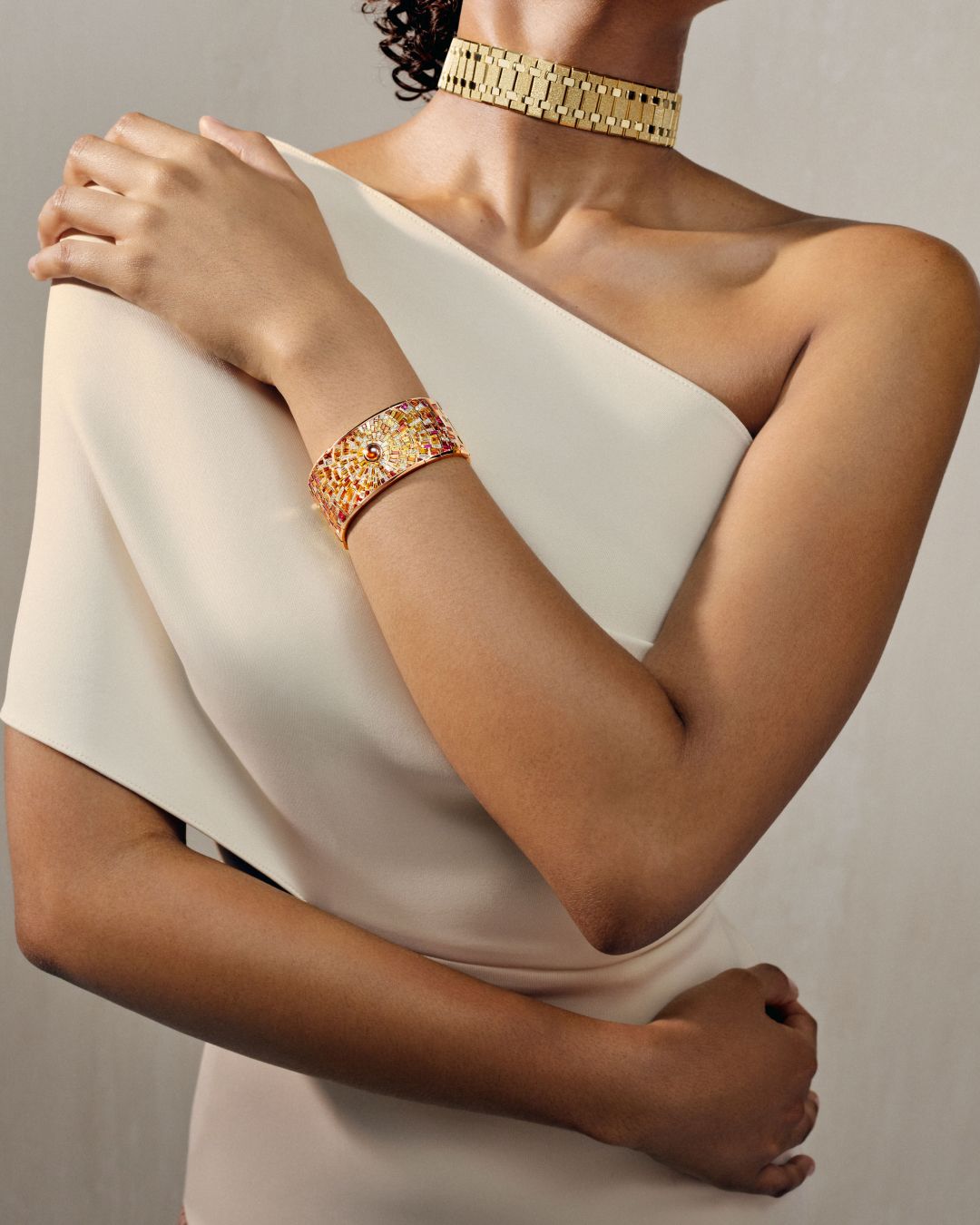 Model wears a Royal Oak Joaillerie gold choker and gemstone cuff