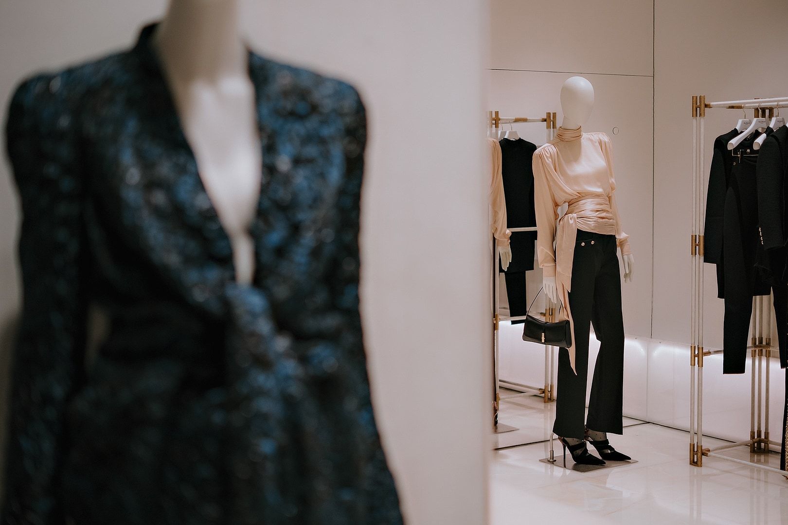 Ready-to-wear mannequins and clothing rails inside Balmain’s Via della Spiga boutique