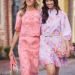 Two models wear pink and lavender looks from Belk’s Sewing Down South x Crown & Ivy coastal collection.