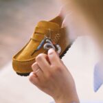 Customising a brown Birkenstock shoe with decorative details