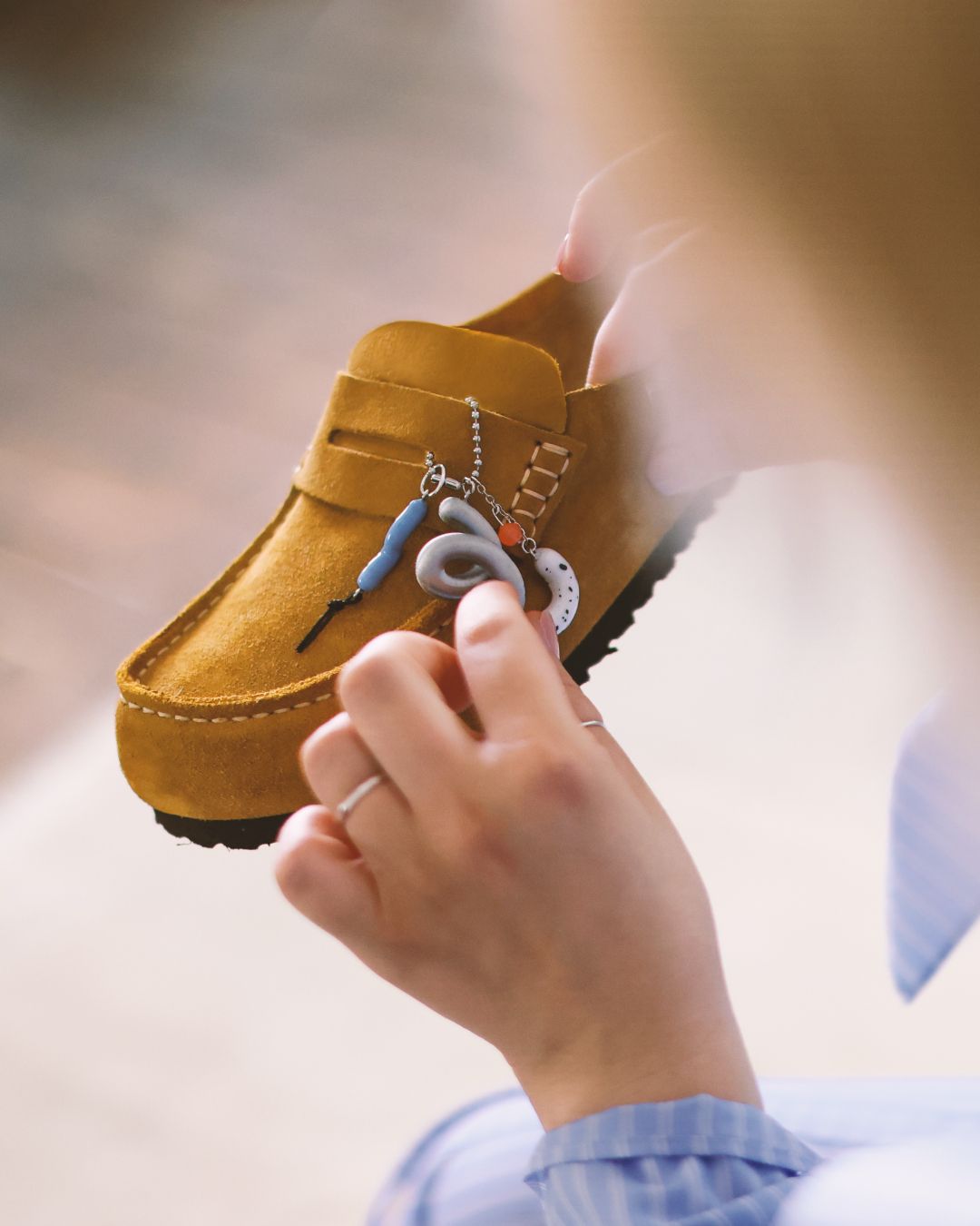 Customising a brown Birkenstock shoe with decorative details
