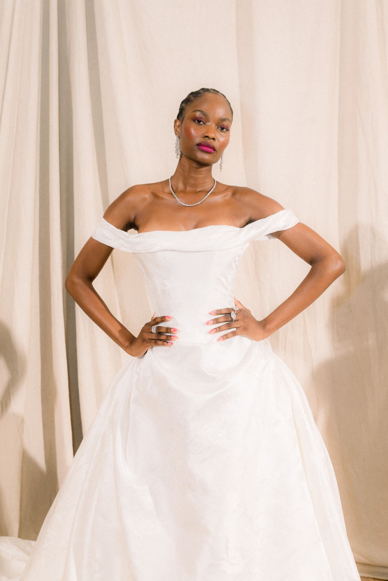 Bridal model in an off-the-shoulder white gown at the Ines Di Santo presentation