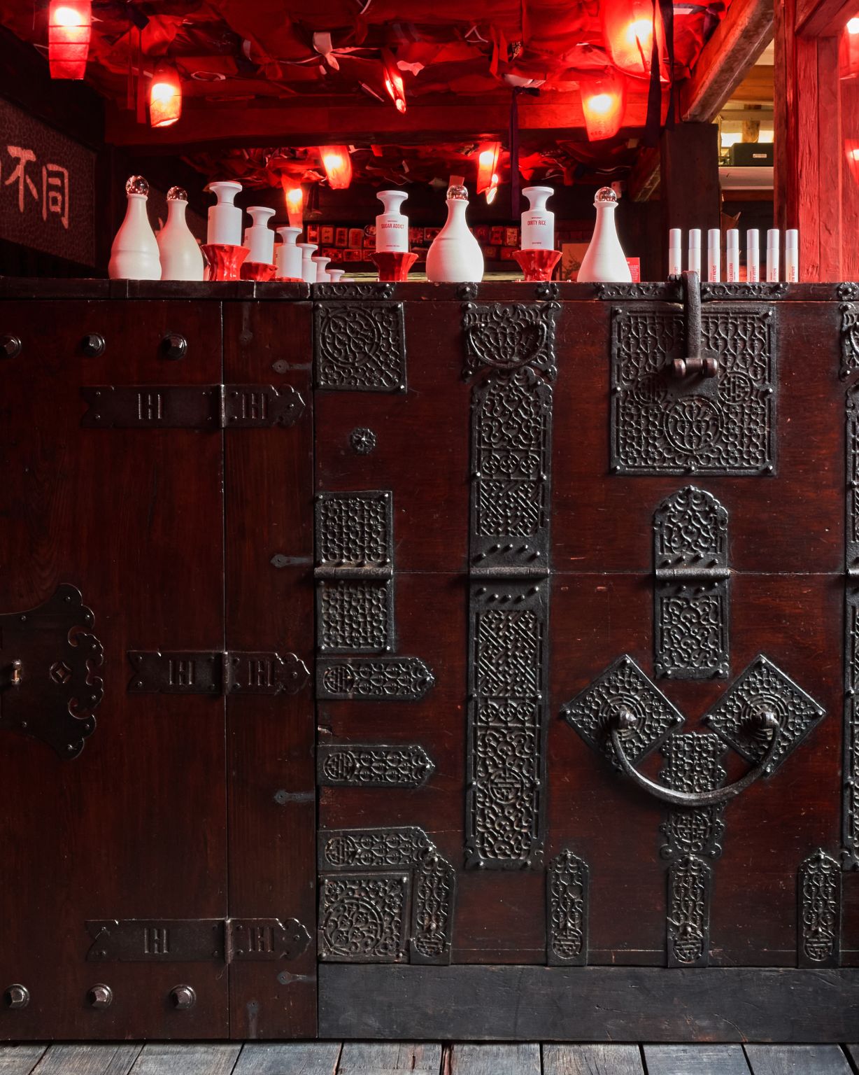 Antique-style cabinet beneath fragrance displays at BORNTOSTANDOUT