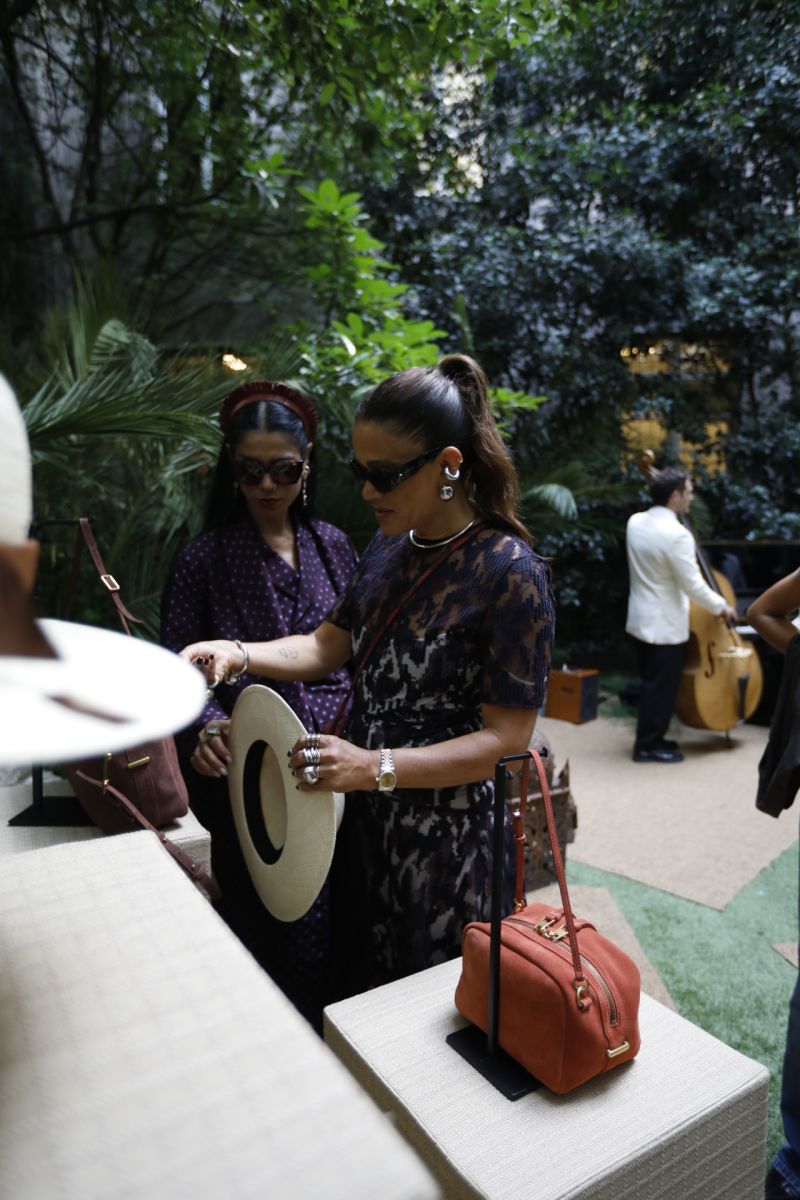 Guest examining a Borsalino hat and leather accessories at the presentation