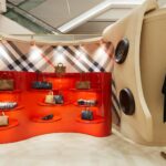 Red accessories alcoves and large button details inside the Burberry Seoul pop-up
