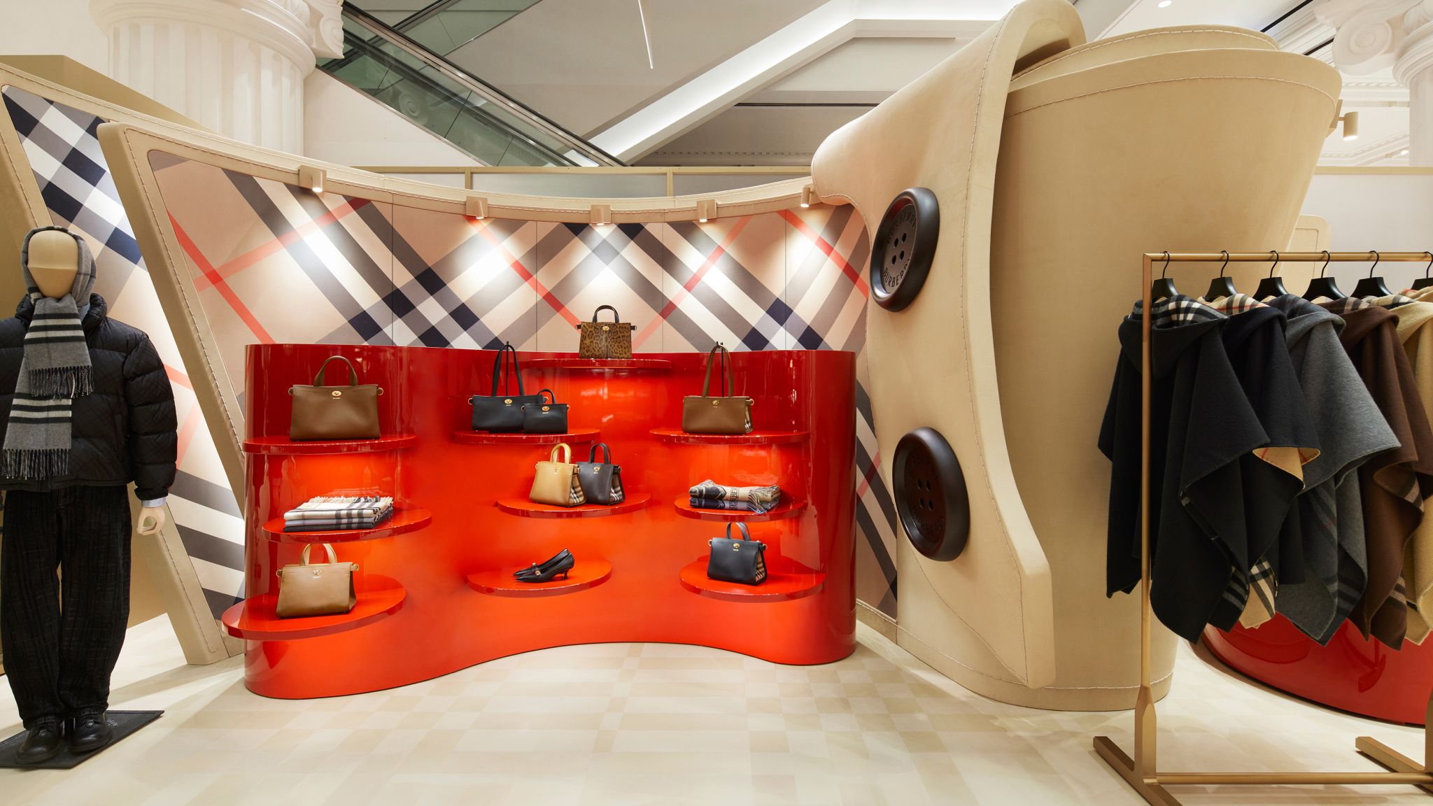 Red accessories alcoves and large button details inside the Burberry Seoul pop-up