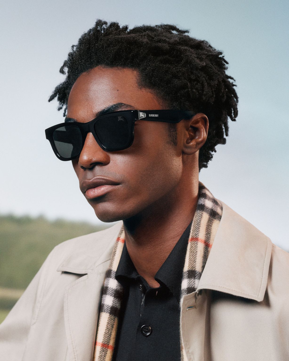 Ahmed Richards wearing black Burberry sunglasses and a checked scarf in the Autumn Winter 2026 eyewear campaign