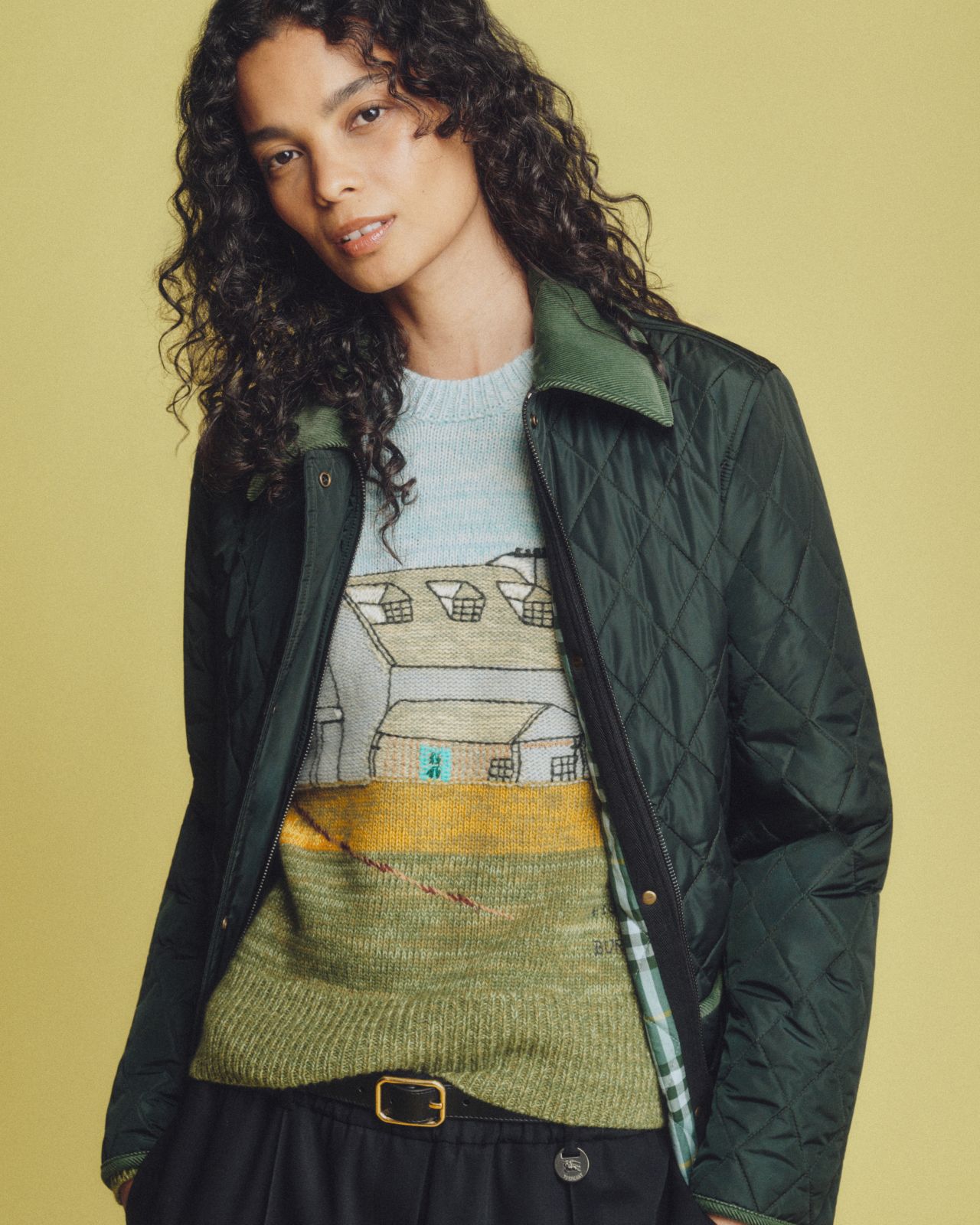 Model wearing a quilted Burberry jacket and artwork-print top from the Highgrove capsule