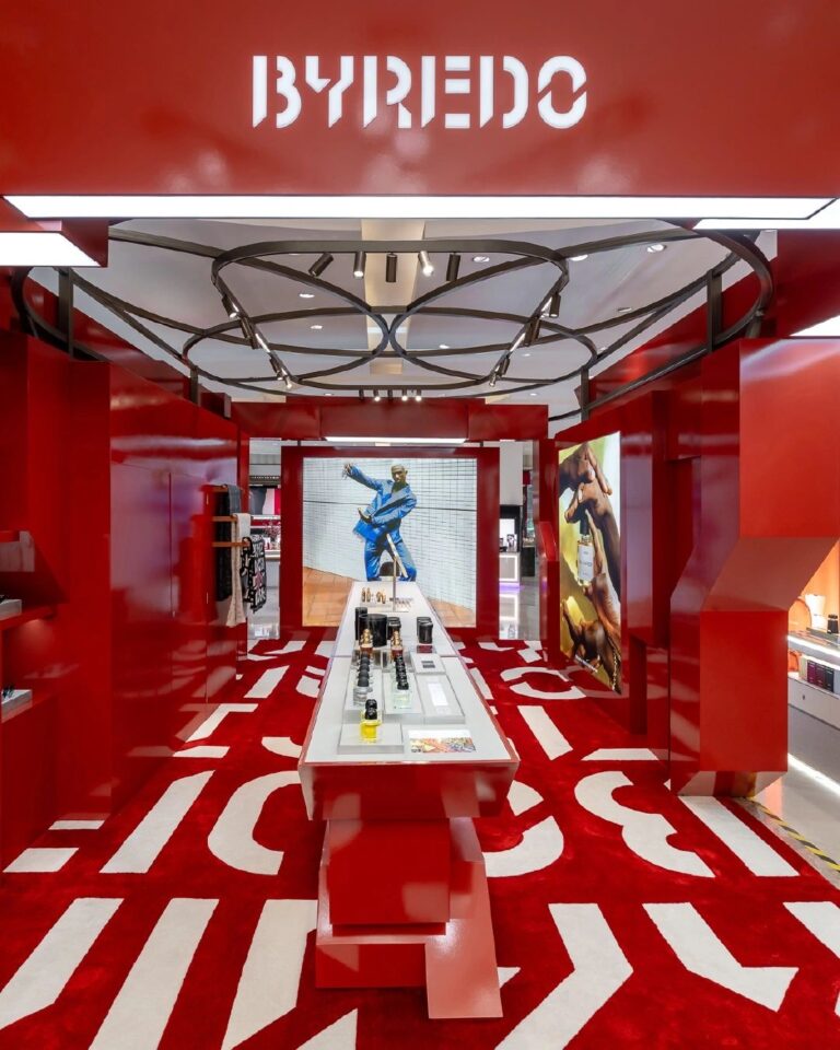 Red Byredo retail installation with fragrance displays, photograph 1