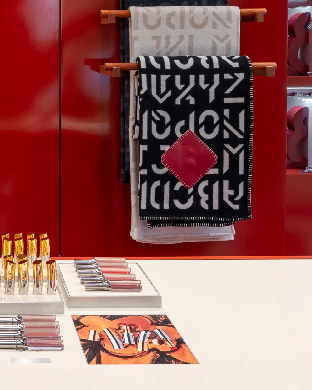 Red Byredo retail installation with fragrance displays, photograph 4