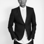 Ayub Mohamed in a black blazer and white shirt.