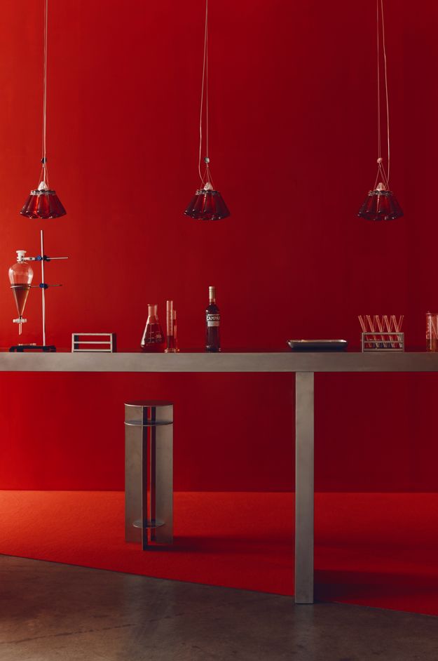 Red laboratory-inspired Campari event scenography and service counter