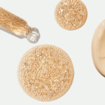 Golden encapsulated droplets and a white cosmetic cream texture shown in Capsum imagery.