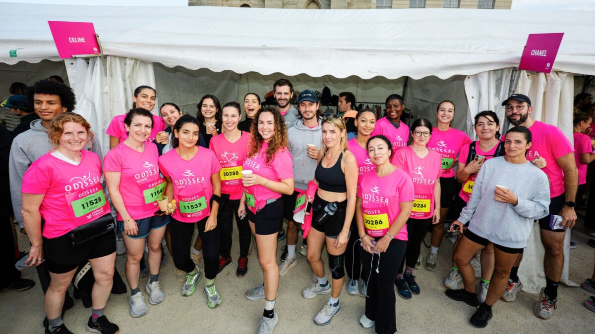 Celine employees pose together in pink Odysséa event shirts
