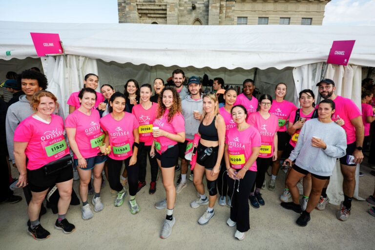 Celine employees pose together in pink Odysséa event shirts