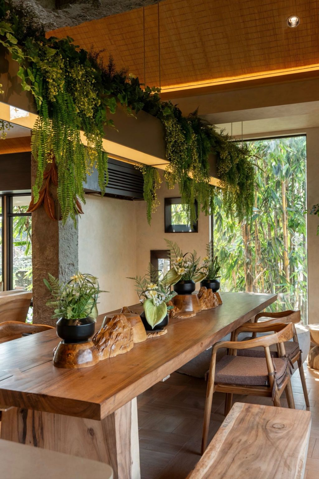 Timber counter beside a large window and greenery