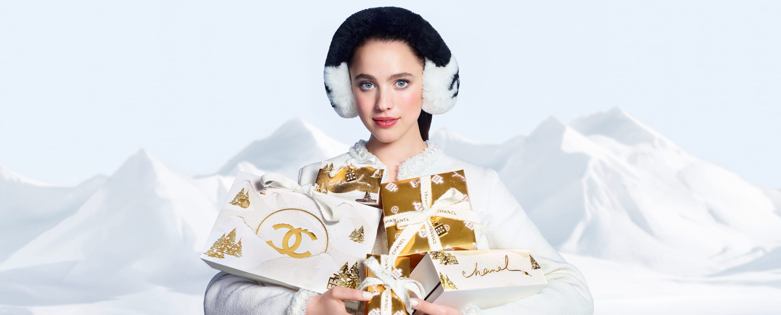 CHANEL holiday campaign portrait with gold and white gifts
