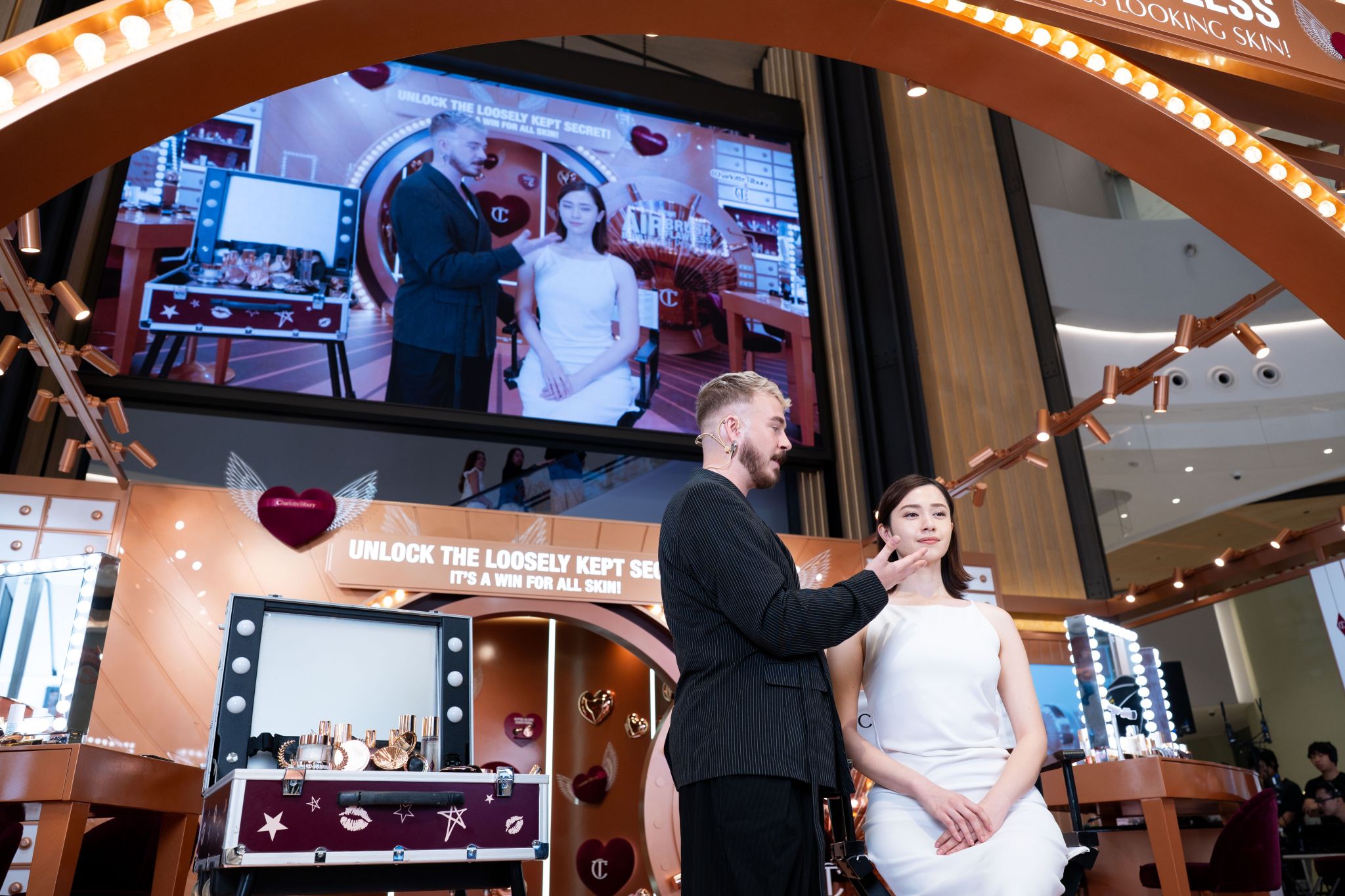 Makeup artistry demonstration displayed on a screen at Hysan Place