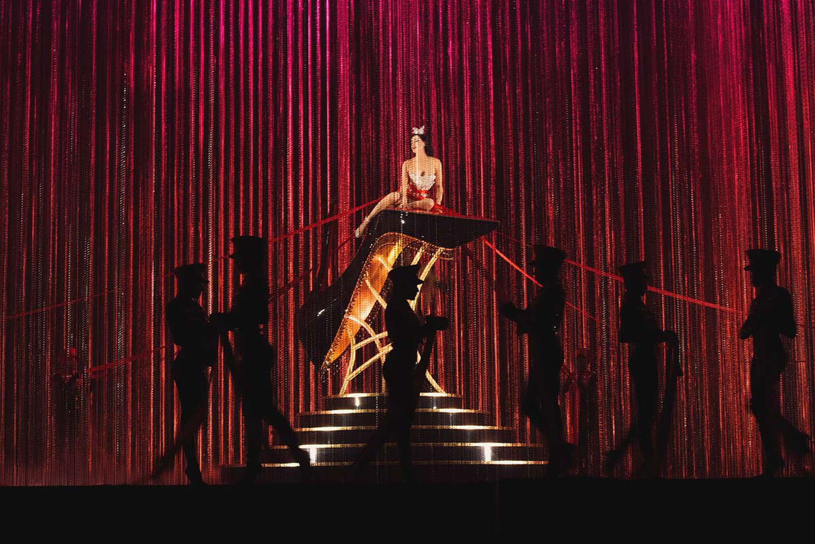Dita Von Teese above the stage in Christian Louboutin's Eternal Youth presentation