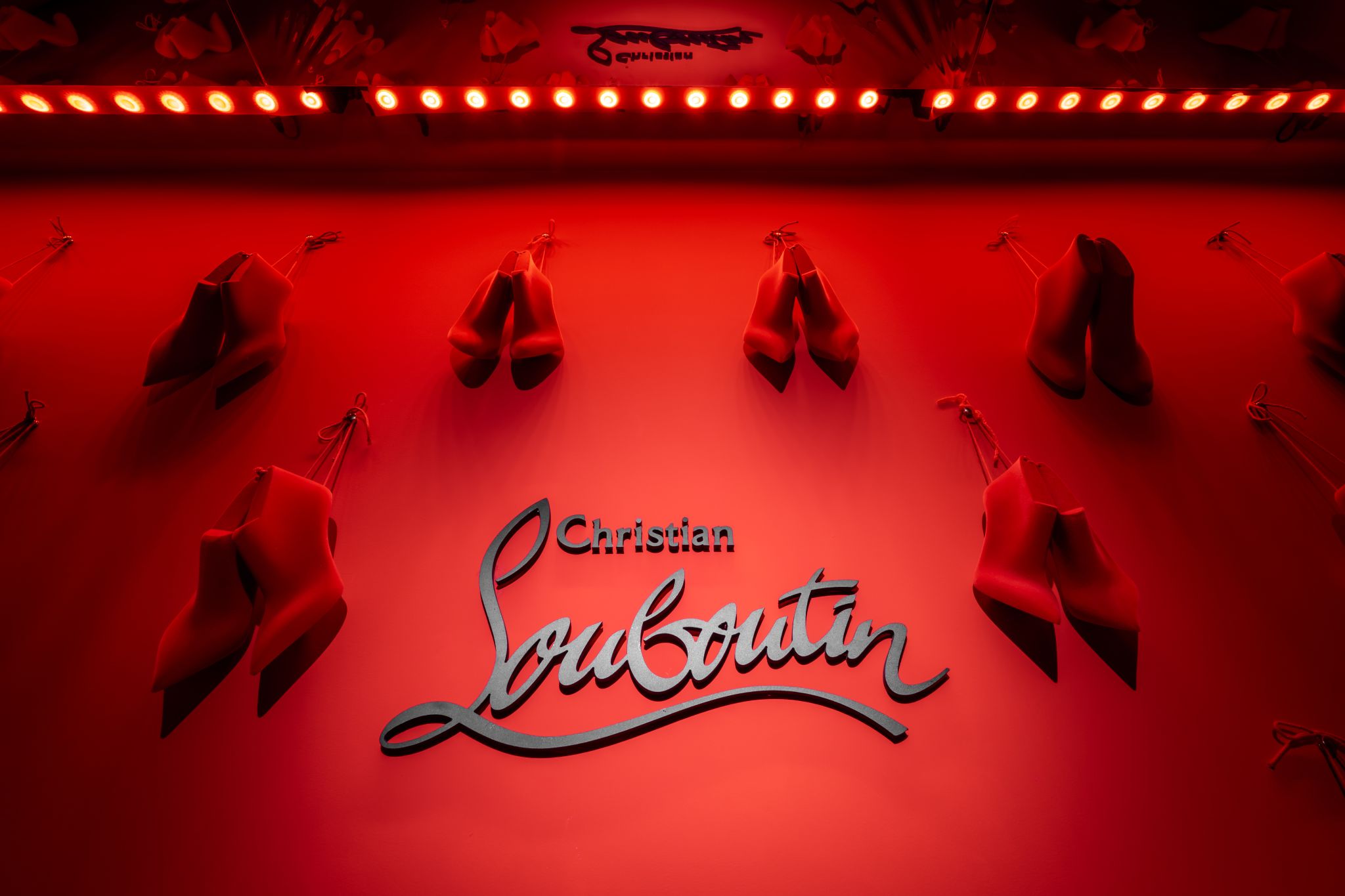 Red Christian Louboutin display at the Paris client trunk show