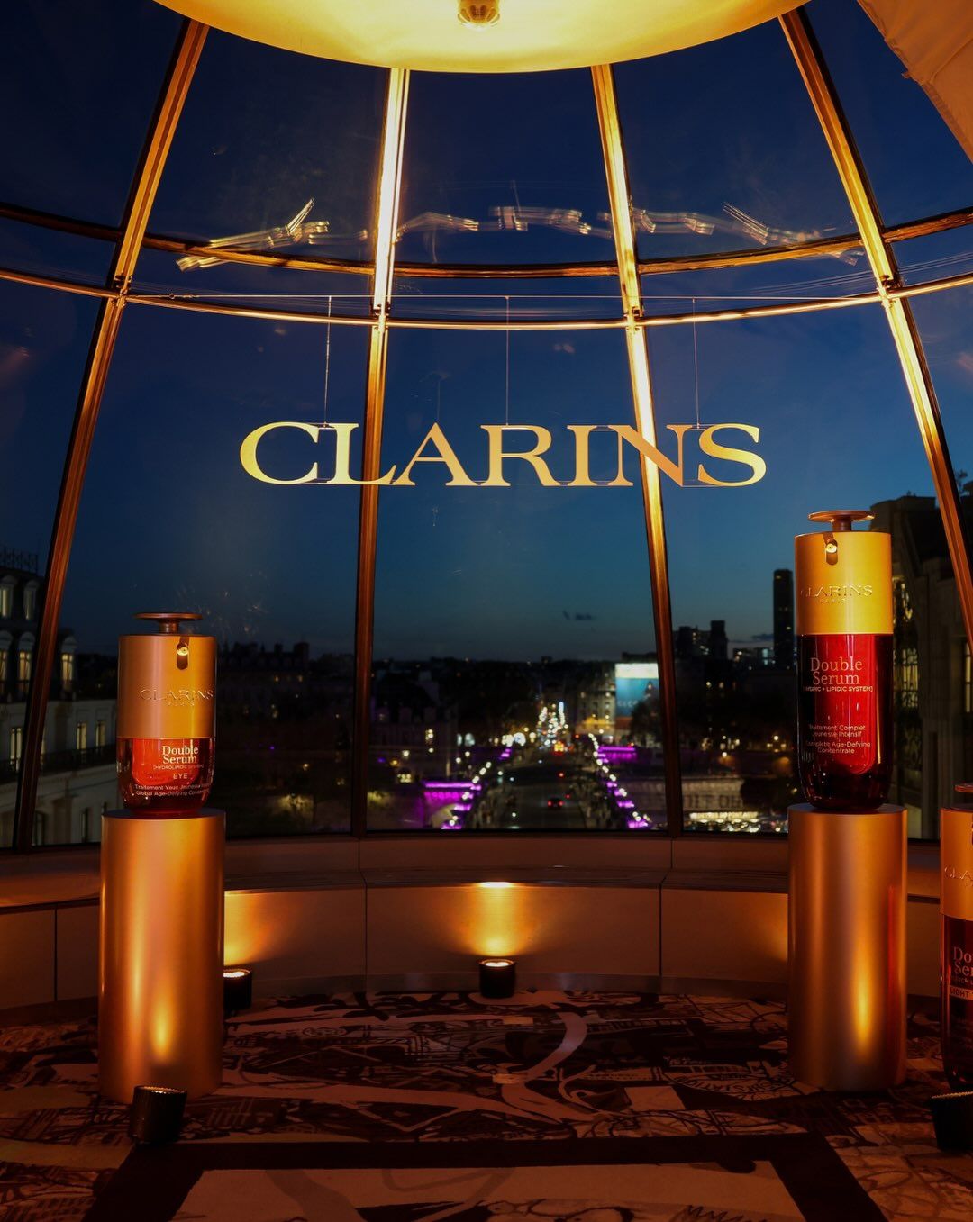 Clarins Double Serum display overlooking Paris at the brand's Fashion Week dinner