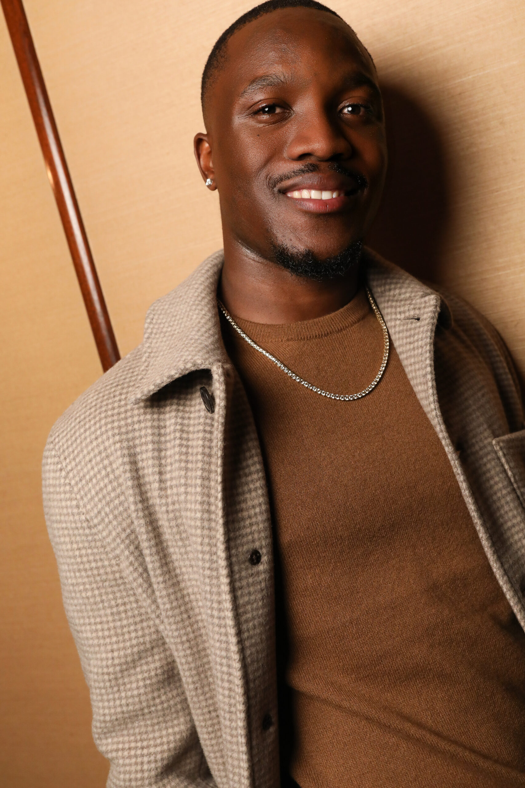 Close portrait of Letsile Tebogo wearing diamond jewelry