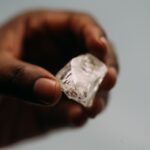 A rough diamond held for inspection