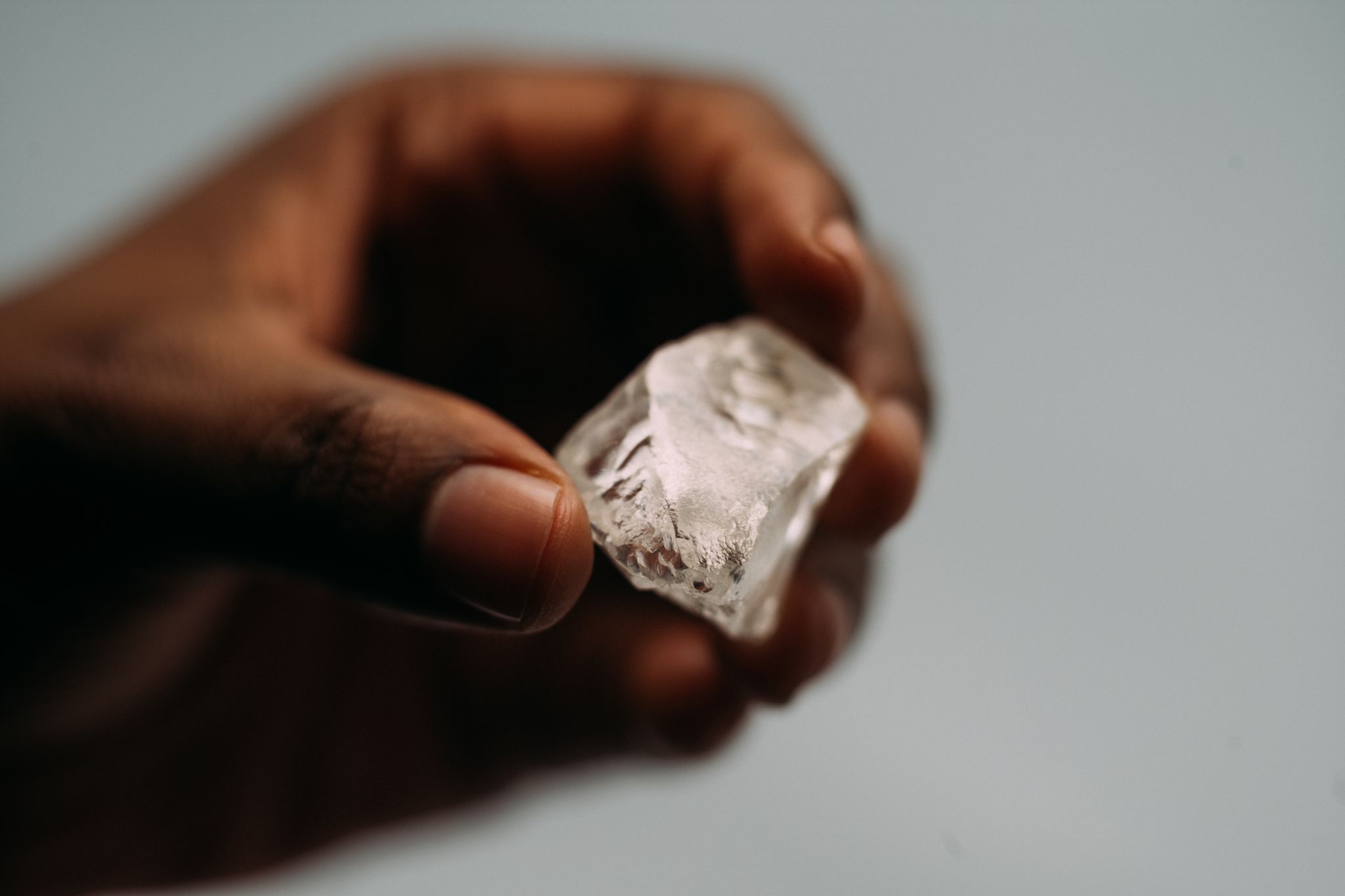 A rough diamond held for inspection