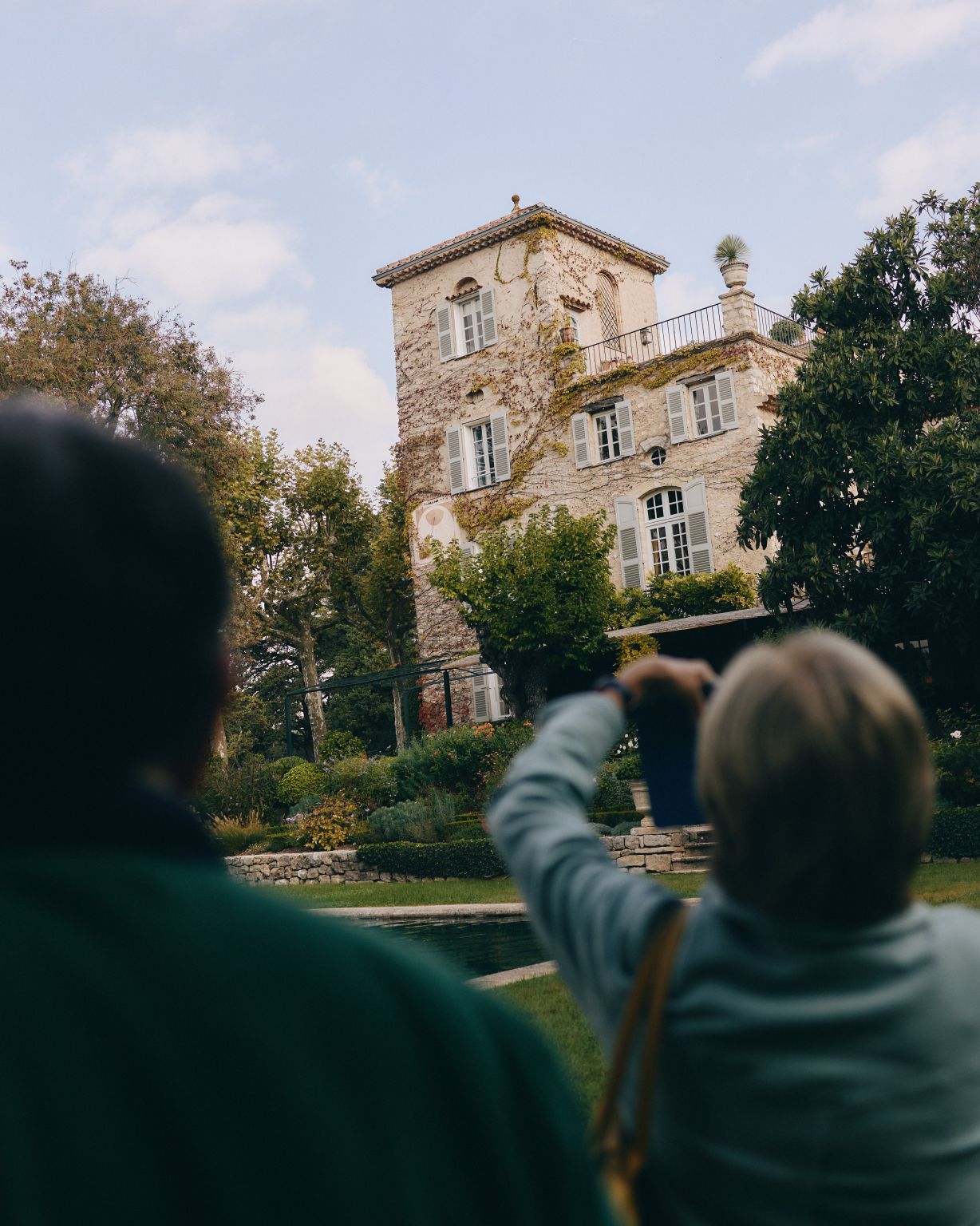 Visitors look toward Château de La Colle Noire from the gardens