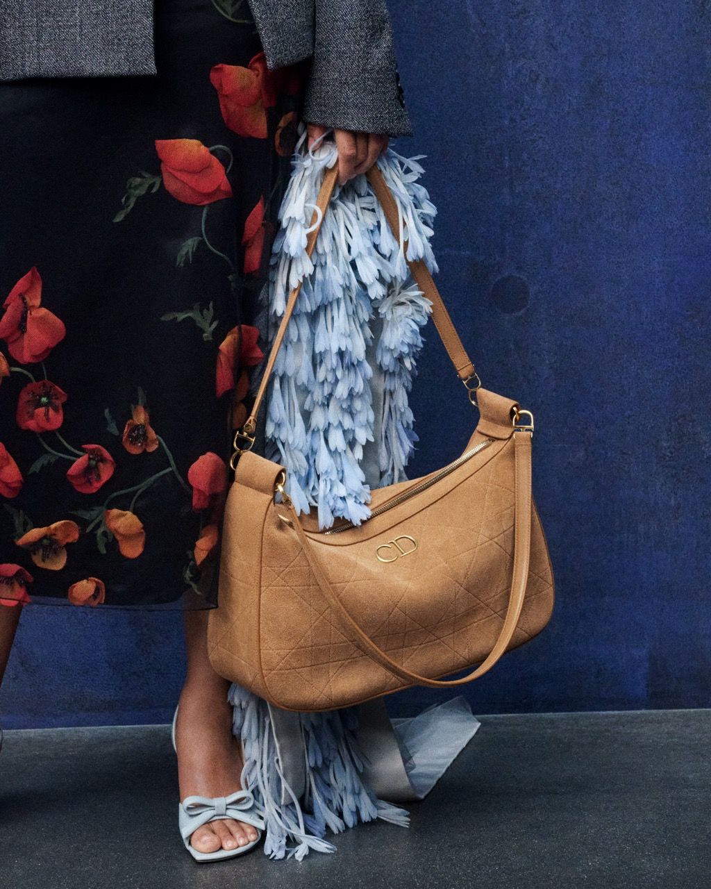 Dior campaign detail featuring a tan shoulder bag