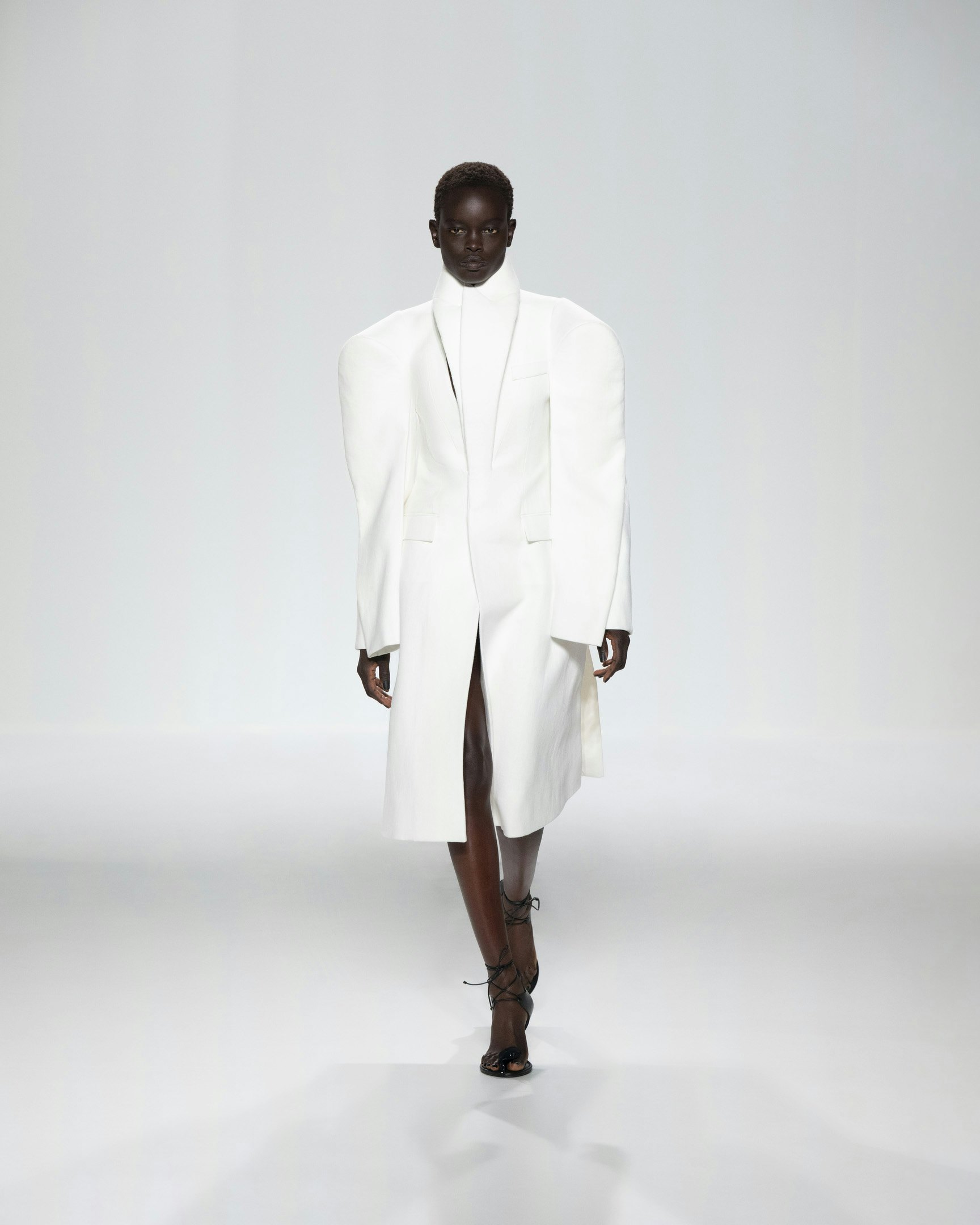 White high-collared tailored coat on the Jean Paul Gaultier runway