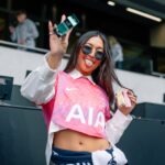 Attendee holding an e.l.f. beauty product at Tottenham Hotspur Stadium