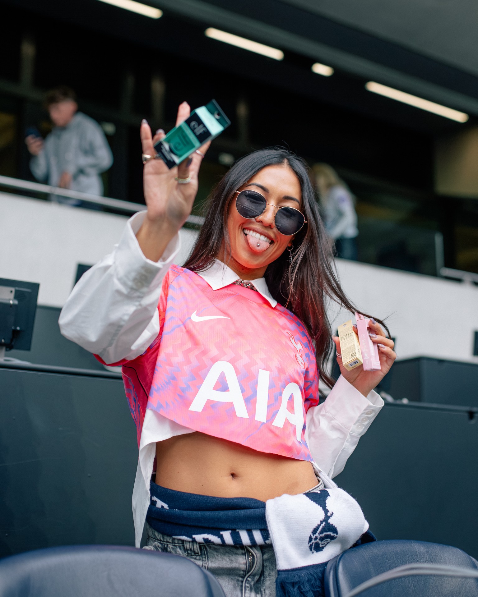 Attendee holding an e.l.f. beauty product at Tottenham Hotspur Stadium