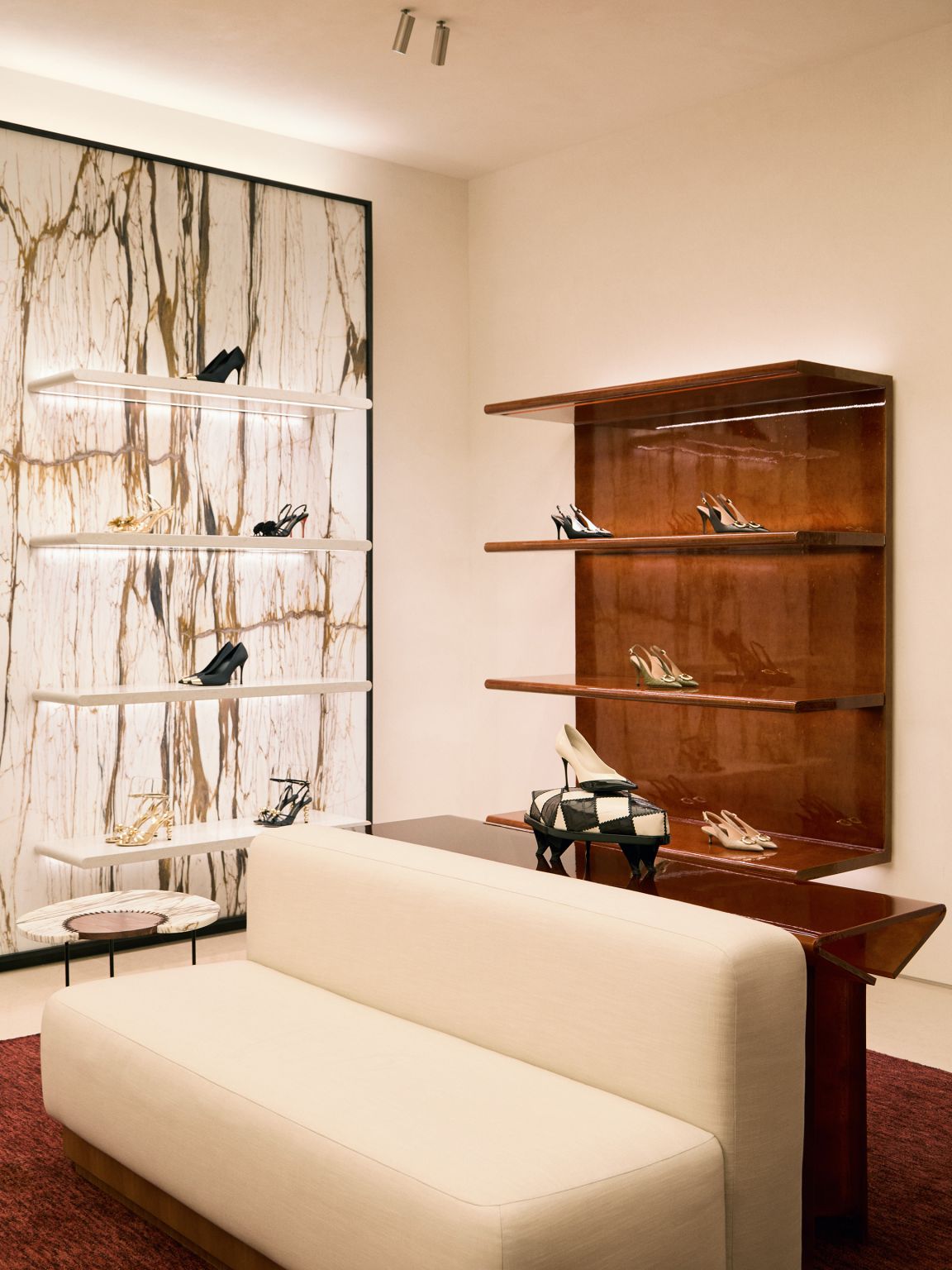 Seating area beside shelving and a patterned feature wall