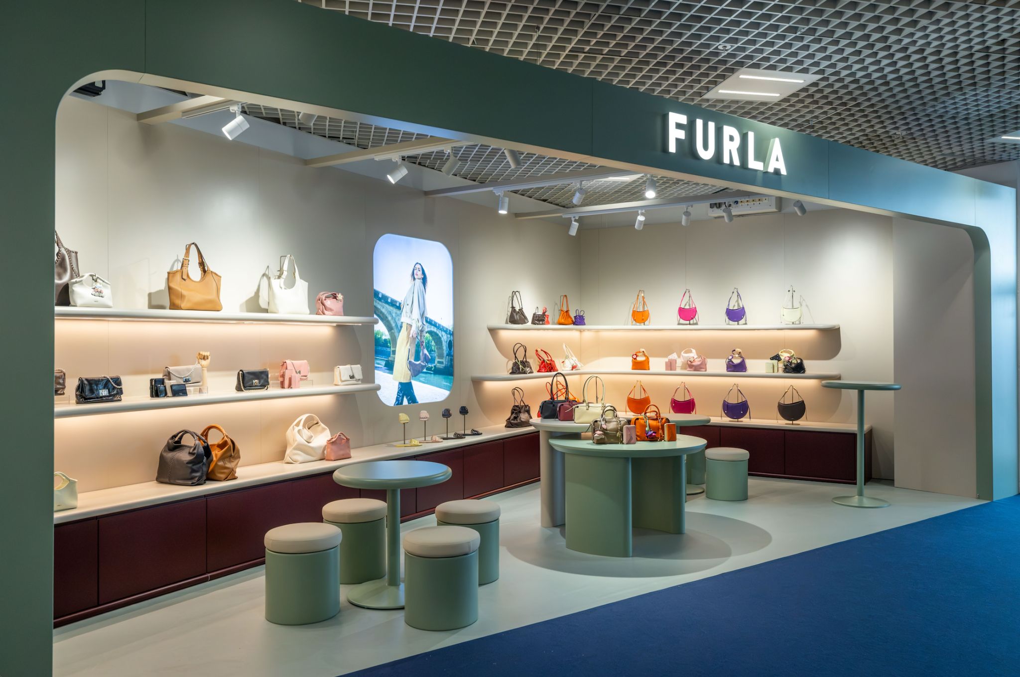 Furla handbag display and seating area inside its TFWA 2026 exhibition stand