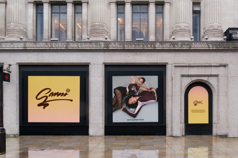 Exterior of a GANNI store with co-branded lululemon collaboration window graphics