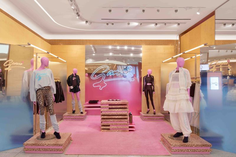 Pink GANNI x lululemon retail display with leopard-print platforms