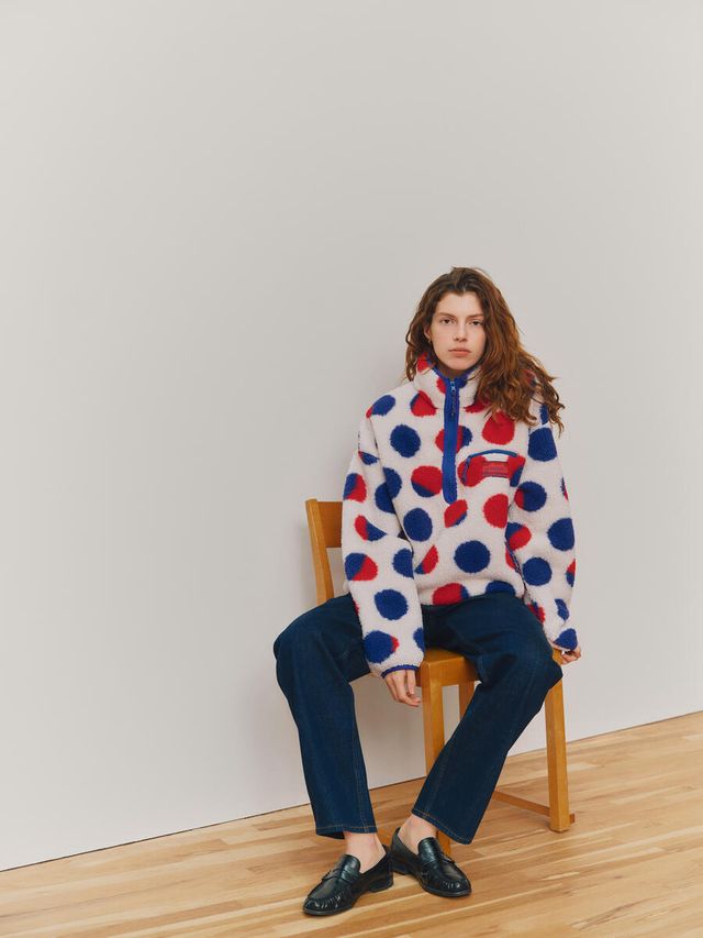 Model in red-and-blue dotted Gap x Whitney sherpa pullover inspired by Roy Lichtenstein