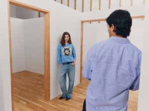 Gap x Whitney campaign scene with model in blue graphic sweater